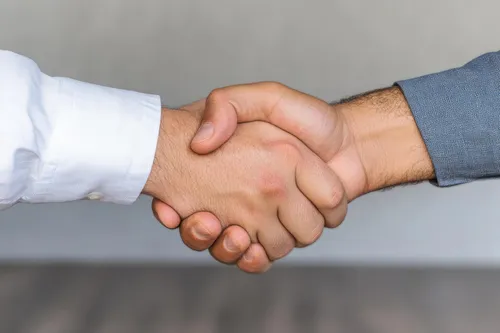 A stern business handshake
