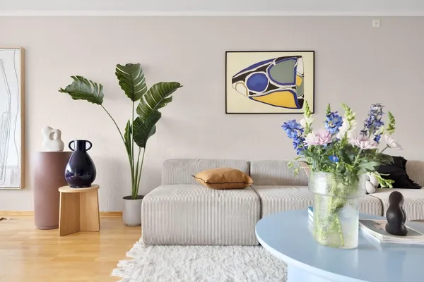 Interior of a living room with a couch and decorative plants